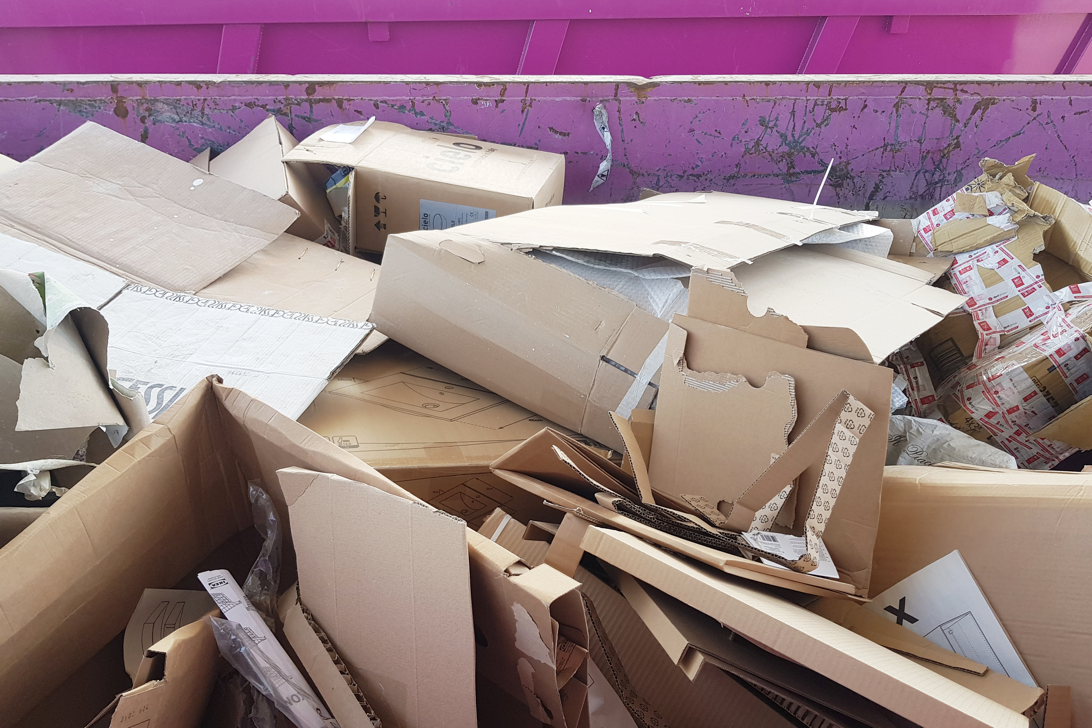 Stacked brown corrugated cardboard sheets for recycling