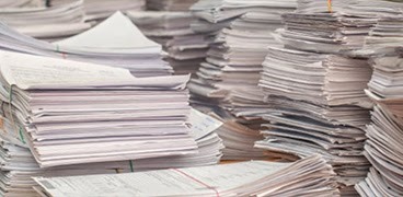 Pile of white office paper and documents ready for recycling